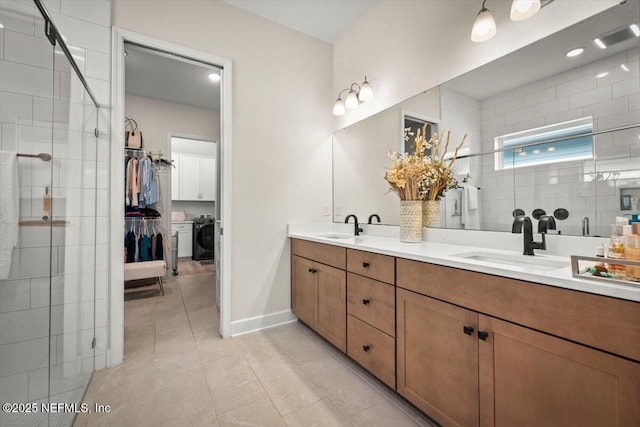 full bath with double vanity, tiled shower, and a sink