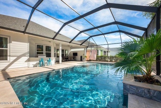 outdoor pool with a lanai, a patio, and ceiling fan