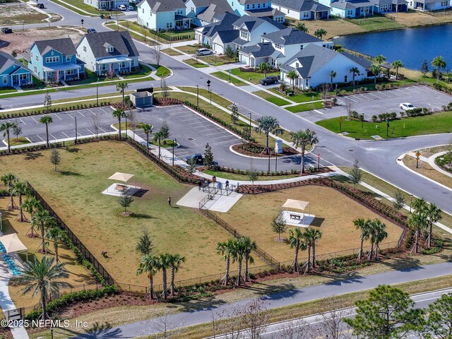 drone / aerial view featuring a water view and a residential view