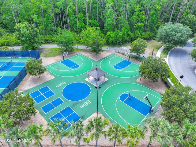 view of basketball court with community basketball court and fence