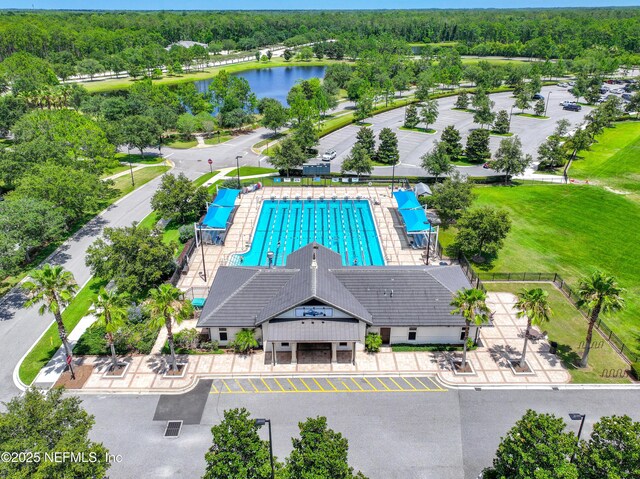 aerial view with a water view and a view of trees