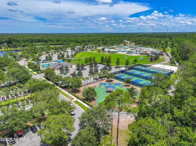 bird's eye view with a water view and a wooded view