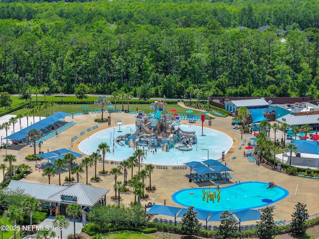 view of pool with a wooded view