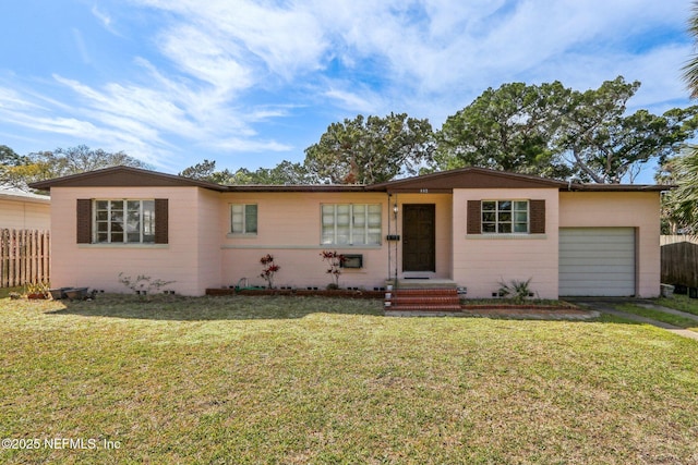 single story home with a front lawn, fence, driveway, and an attached garage