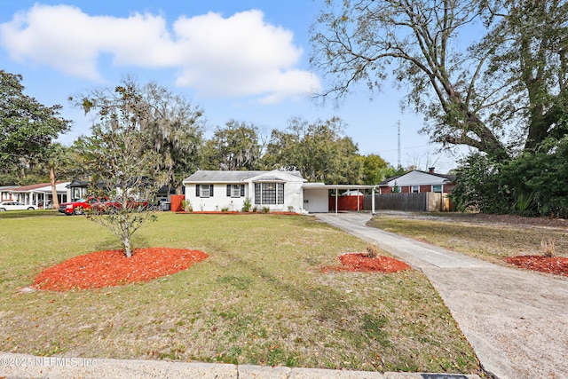 ranch-style house with driveway, a front lawn, fence, and an attached carport