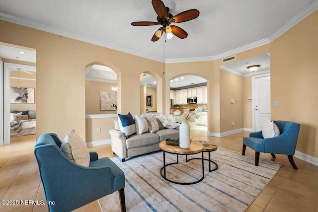 living room with ornamental molding, visible vents, baseboards, and light tile patterned floors