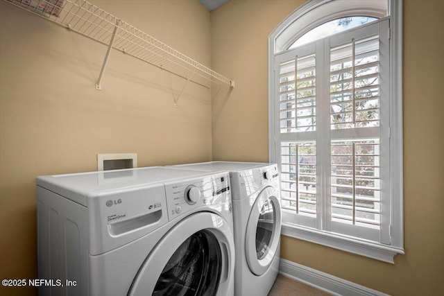 laundry area with baseboards, laundry area, and washer and dryer