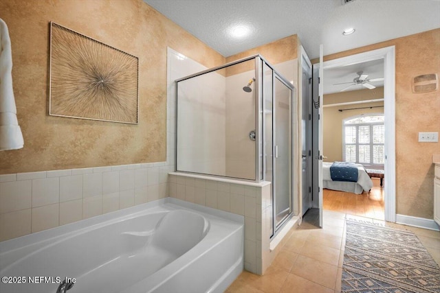 bathroom featuring a bath, tile patterned flooring, a shower stall, and connected bathroom