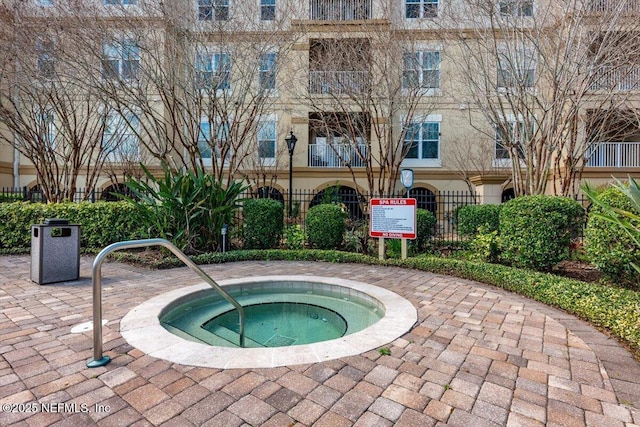 view of swimming pool featuring a community hot tub