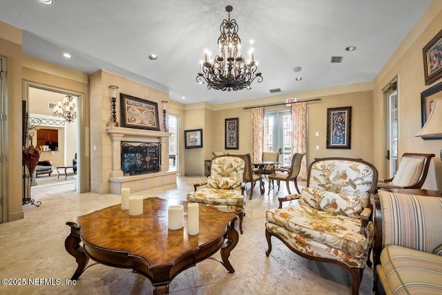 sitting room with french doors, a tile fireplace, visible vents, and recessed lighting