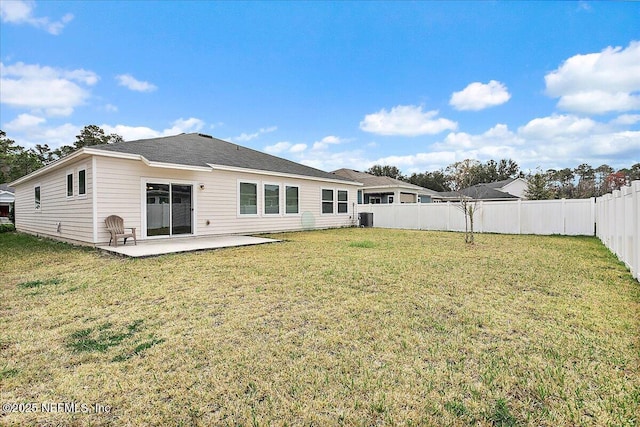 rear view of house featuring a patio area, a yard, and central AC unit