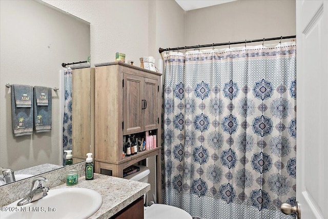 bathroom with vanity, a shower with curtain, and toilet