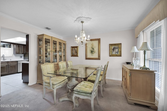 dining space with ornamental molding, light carpet, visible vents, and an inviting chandelier