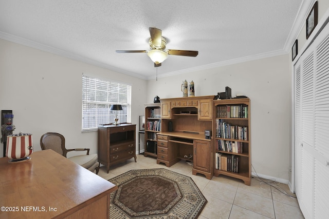 office area with a textured ceiling, ceiling fan, light tile patterned flooring, baseboards, and ornamental molding