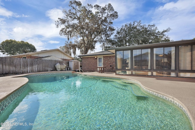 view of swimming pool featuring a patio area, fence, and a fenced in pool