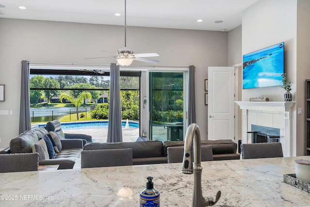 95384 Bermuda Dr, Fernandina Beach, FL 32034 - living area featuring ceiling fan, a tile fireplace, a water view, and recessed lighting