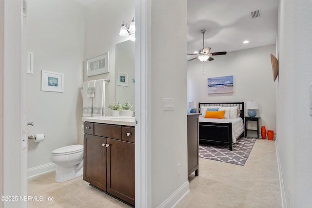 95384 Bermuda Dr, Fernandina Beach, FL 32034 - bathroom featuring a ceiling fan, vanity, baseboards, toilet, and visible vents