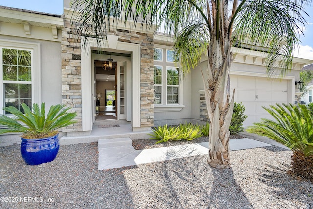 95384 Bermuda Dr, Fernandina Beach, FL 32034 - view of exterior entry with stucco siding, an attached garage, and stone siding