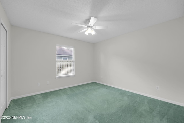 unfurnished room with ceiling fan, carpet floors, a textured ceiling, and baseboards