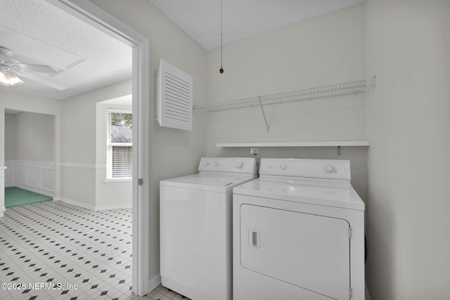 laundry area with a ceiling fan, laundry area, washer and clothes dryer, and a textured ceiling