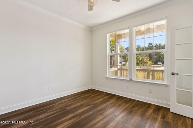 unfurnished room featuring dark wood-style floors, crown molding, plenty of natural light, and baseboards