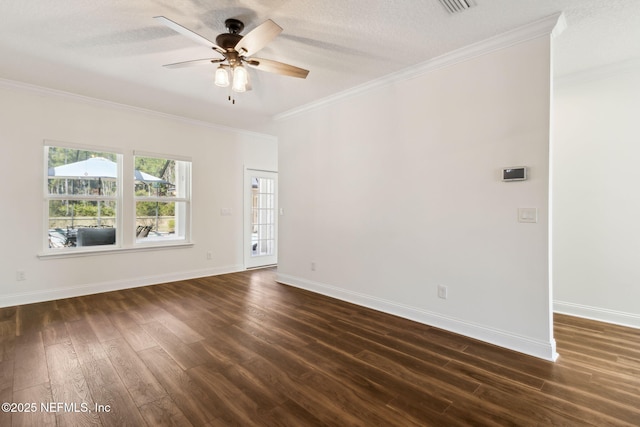 spare room with crown molding, dark wood finished floors, and baseboards