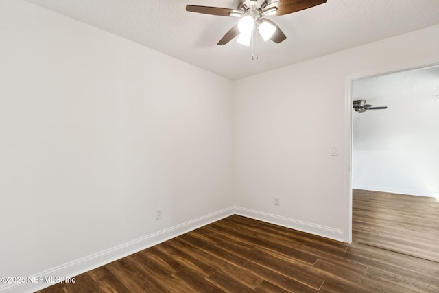 unfurnished room with dark wood-style floors, a textured ceiling, baseboards, and a ceiling fan