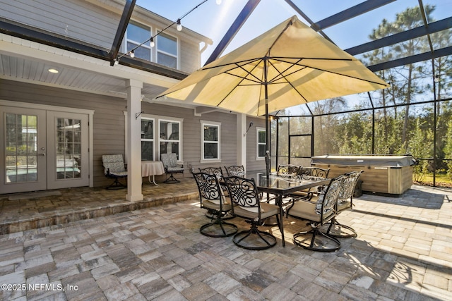 view of patio featuring french doors, a hot tub, and a lanai