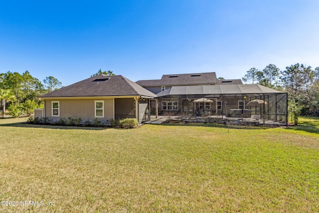 rear view of property featuring glass enclosure and a lawn