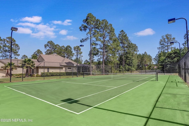 view of sport court featuring fence