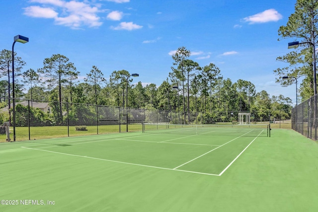 view of sport court featuring fence