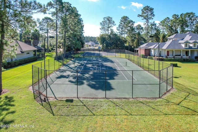 view of sport court featuring fence