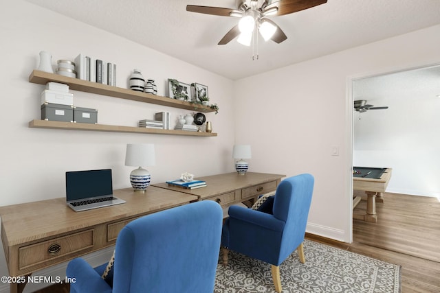 office area with baseboards, a textured ceiling, a ceiling fan, and wood finished floors