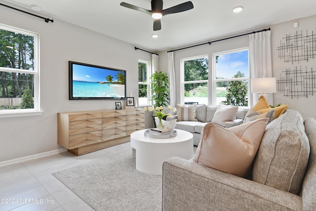 living room with ceiling fan and light tile patterned flooring