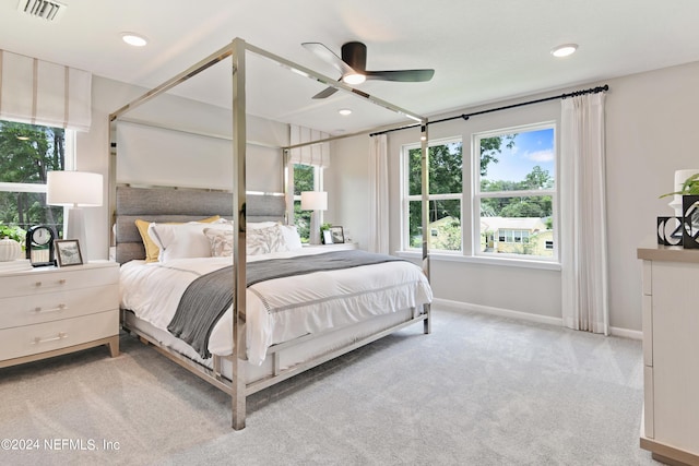 bedroom featuring light colored carpet and ceiling fan