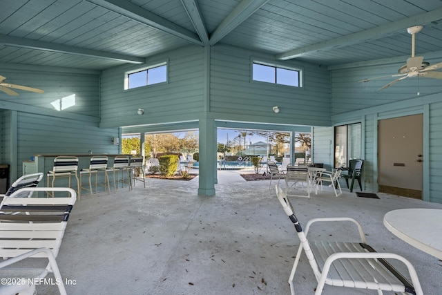 view of patio / terrace with outdoor dry bar, outdoor dining space, and ceiling fan