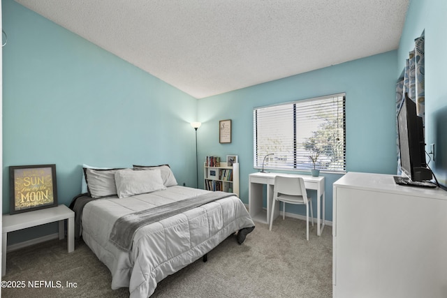 bedroom featuring carpet flooring, baseboards, and a textured ceiling