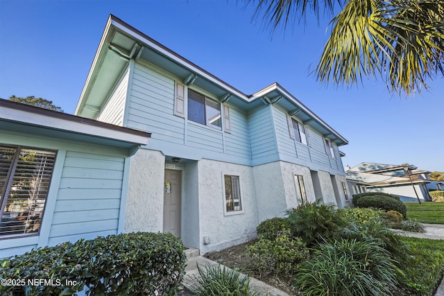 view of side of property featuring stucco siding