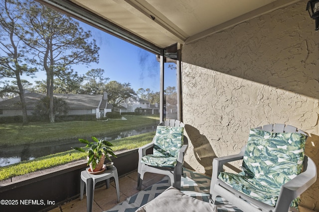 sunroom / solarium with a water view