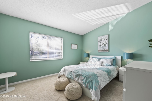 carpeted bedroom featuring a textured ceiling, baseboards, and vaulted ceiling