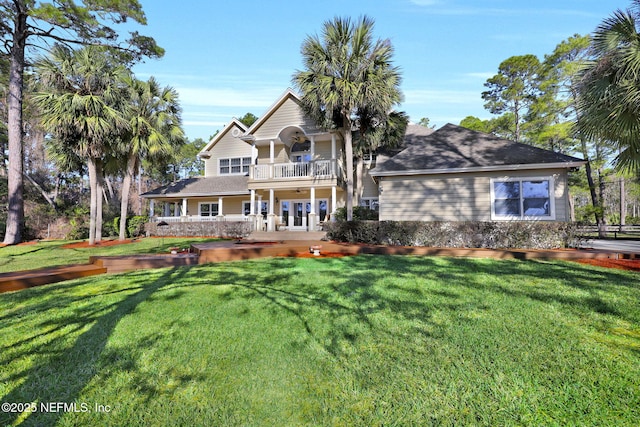 view of front facade with a balcony and a front lawn