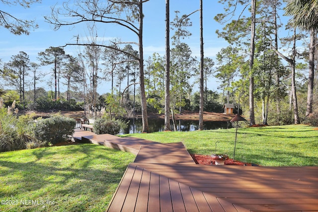 wooden deck featuring a water view and a yard