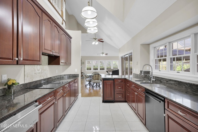 kitchen featuring pendant lighting, stainless steel dishwasher, a sink, dark stone countertops, and black electric cooktop