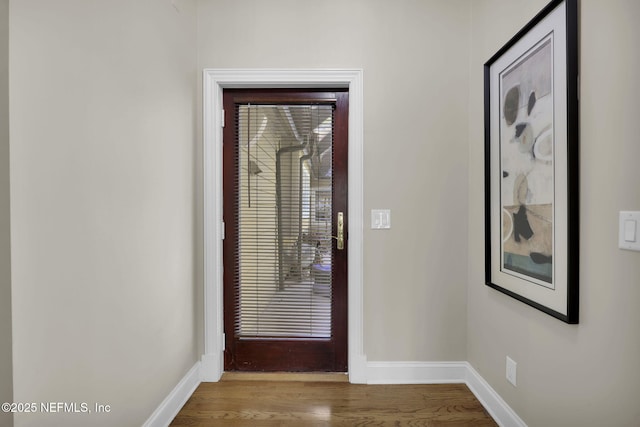 entryway featuring baseboards and light wood-style floors