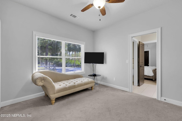 living area with light carpet, visible vents, and baseboards