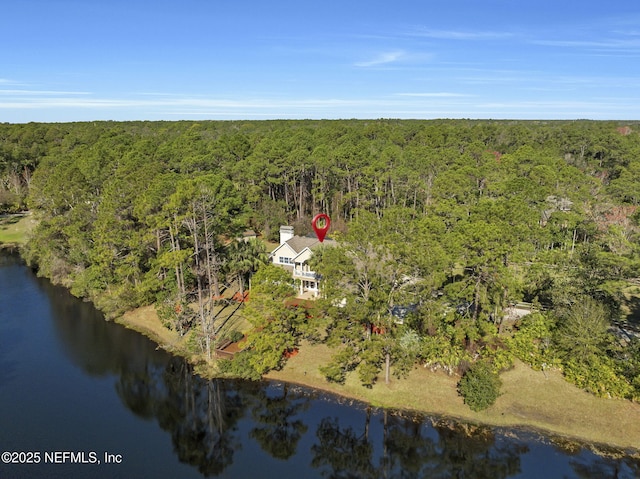 drone / aerial view featuring a water view and a forest view