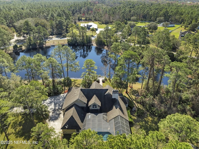 drone / aerial view featuring a water view and a forest view