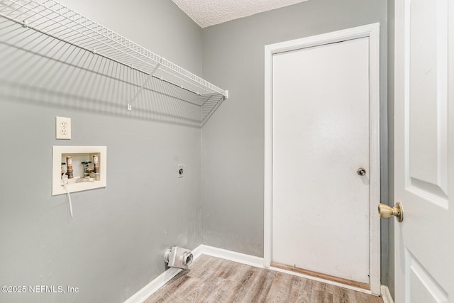 laundry area with washer hookup, laundry area, wood finished floors, electric dryer hookup, and a textured ceiling