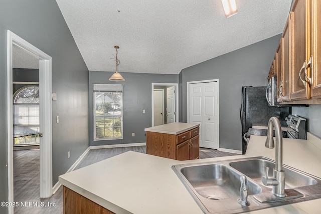 kitchen featuring a kitchen island, lofted ceiling, brown cabinets, stainless steel range with electric stovetop, and a sink