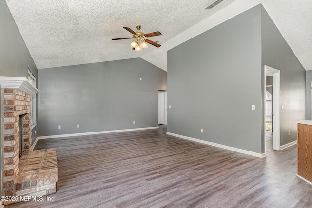 unfurnished living room featuring wood finished floors, baseboards, visible vents, a fireplace, and ceiling fan